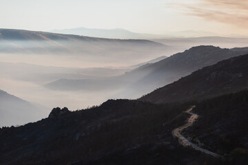 Fototapeta na wymiar Mountain landscape on a foggy calm morning after a wildfire 