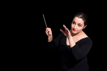 Shot of music woman director conducting symphonic orchestra