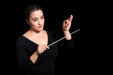 Shot of music woman director conducting symphonic orchestra - obrazy, fototapety, plakaty