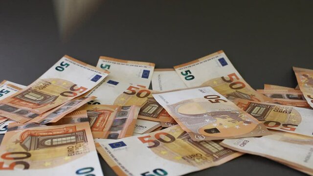 Falling 50 euro banknotes on a gray background. Close up view.