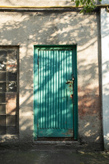 old green door with stripes in abandoned building
