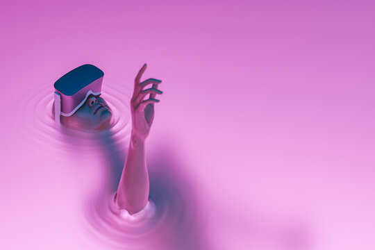 surreal girl with VR glasses immersed in liquid