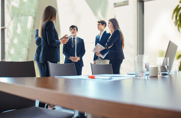 Team young professionals having casual discussion in office. Executives having friendly discussion during break
