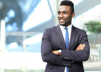 Successful African American businessman businessman standing in office