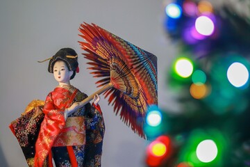 JAPANESE DOLL GEISHA WITH BLURRY LIGHTS 