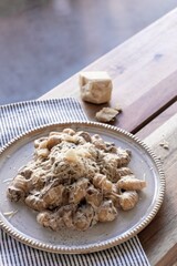 Gnocchi with vegan creamy sauce, porcini mushrooms and vegan cheese