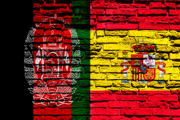 Background with flag of Spain and Afghanistan on a brick wall