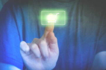 Woman touching e-commerce button. Button with a shopping cart on a virtual interface. Woman makes...