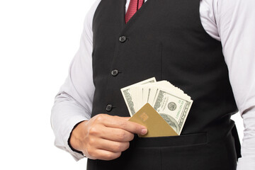 Handsome business man in black suit put or take out credit card and money in pocket isolated on...