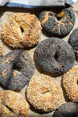Freshly baked sesame and poppy seeded bagels. Top view.