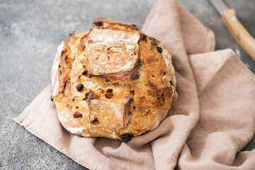 Sourdough dessert bread with dried apricots and walnuts on a napkin.