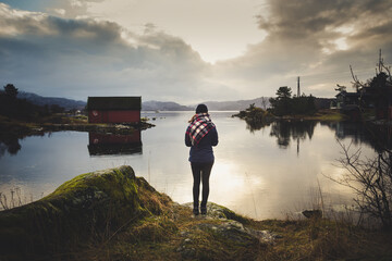 Woman looking at a fjord landscape in Norway