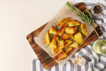 Fried potatoes with garlic and rosemary in the oven. Concept: food for Christmas and New Year. Top view.Copy space