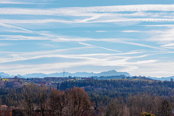 Fototapeta na wymiar Transmission tower near Hohenpeissenberg in Bavaria against a slightly blurred backdrop of the Ammergau Alps in pastel colors