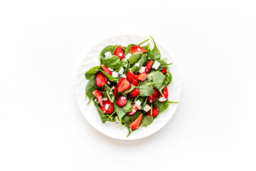 Spinach salad with strawberry and goat cheese, top view