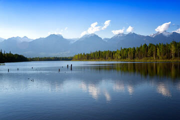Landscape with mountains reflecting in the water on summer day. Buryatia, Tunkinskaya valley