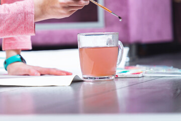 The hand of a little girl paints