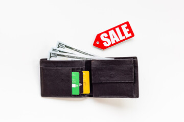 Discount shopping day - sale tag and wallet with banknotes and bank cards