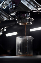 Hot espresso shot flowing from machine