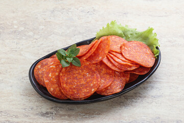 Sliced pepperoni sausage in the bowl