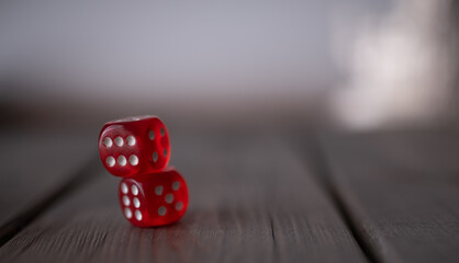 two red game dice on wooden background