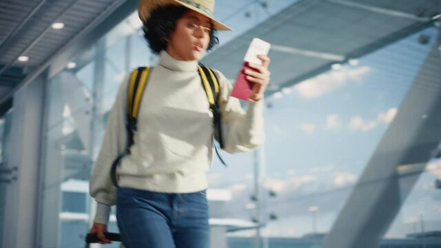 Airport Terminal: Black Woman Holds Ticket, in a Hurry is Late and Runs Through Airline Hub to the Gates and to Her Airplane. African American Female Running for Flight to Vacation Destination