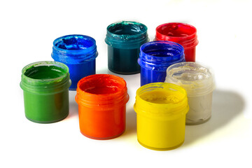 Set of gouache paint pots of different colors on isolated white background. Open paint cans for drawing. Gouache set.