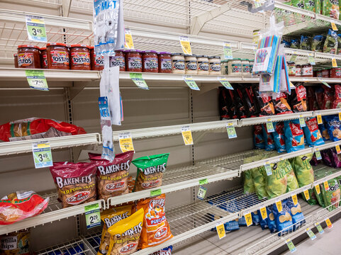 Kirkland, WA USA - circa January 2022: Angled view of food shortage in the snack aisle in a Safeway grocery store during heavy snow storms across Washington.