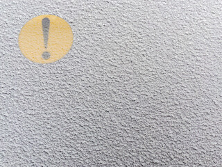 The yellow exclamation mark on the back window of the car covered by snow. Attention novice driver...