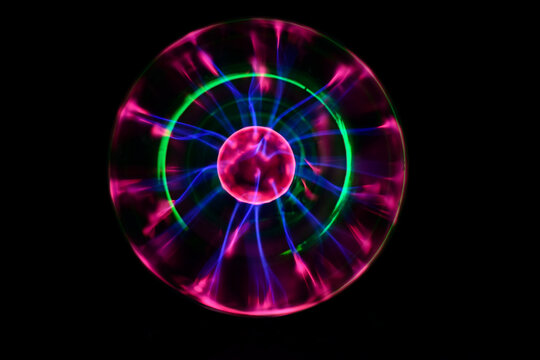 Plasma ball with iridescent different colors on a black background
