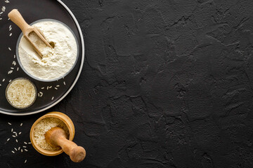 Pestle rice flour - grains with mortar on kitchen table