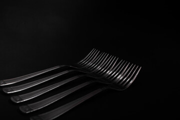 Plugs with metal, silver, lie on a black background