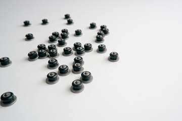 Repair of winter studded tires. Repaired spikes scattered on a white background. Replaced lost car tire spikes.