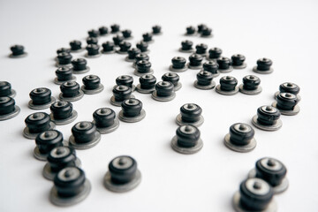 Repair of winter studded tires. Repaired spikes scattered on a white background. Replaced lost car tire spikes.