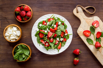 Fresh fruit salad with spinach and strawberry. Healthy happy meal