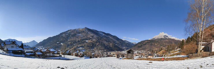 Fototapeta na wymiar Panoramic view on village and Valle di Primiero during sunny day and winter season