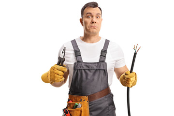 Portrait of a confused electrician holding a cable and pliers