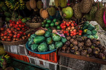 Fruit shop in Thailand. Fruit market in Indonesia Bali island. Street bazaar in Asia. Sale of fresh fruits and vegetables at the market in Thailand. A small grocery store on the street of Bali island