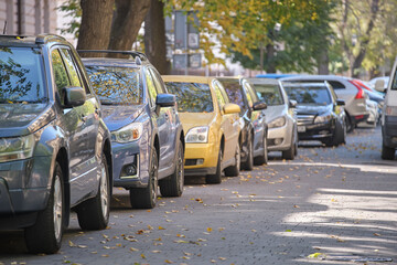 City traffic with many cars parked in line on street side