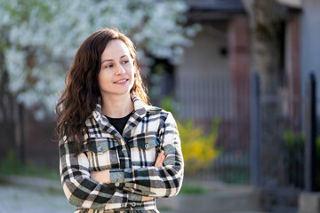 Portrait of happy pretty young woman outdoors on spring sunny day.