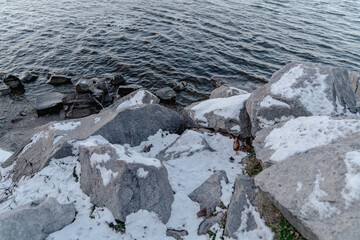 Snow on a stone near the river