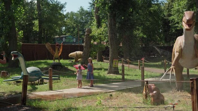 2021.08.12 - Kiev, Ukraine: Motorized Authentic Size Dinosaur Predator Different Mockup in Amusement Forest Park. Exhibition of Moving Models Animals from Jurassic Prehistoric Period in Dinopark