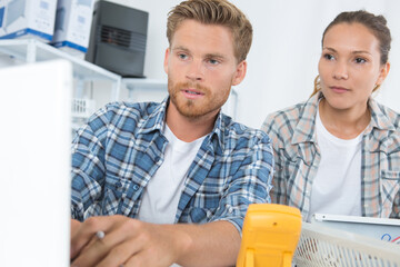 couple fixing television
