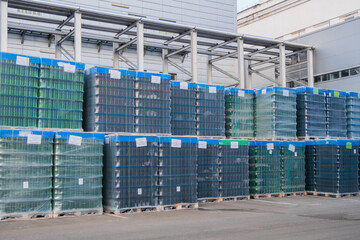 Outdoor bottle storage, finished product of beer factory. Production, manufacture, industrial concept