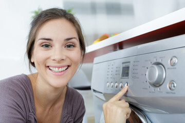 close view of woman pressing button on washing machine