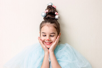 Cheerful portrait of a little girl with styling in the form of a Christmas tree