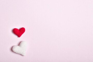 Two hearts lie on a pink background. Background for Valentine's Day. Copy space. Flat lay, top view