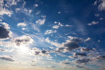 Glowing on the blue sky with clouds . Summer day sky 