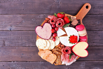 Valentine's Day theme charcuterie board with a selection of cheeses, appetizers and sweets....