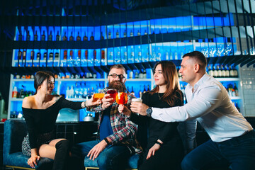 A group of friends drinks alcohol in a bar.